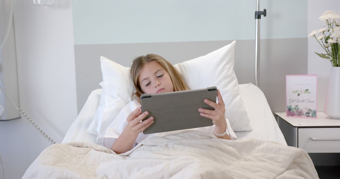 Young Girl Using Digital Tablet While Resting in Hospital Bed - Free Images, Stock Photos and Pictures on Pikwizard.com