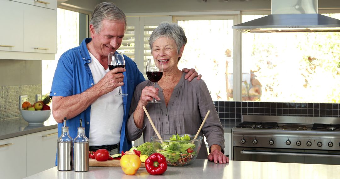 Senior Couple Enjoys Cooking and Wine in Modern Kitchen