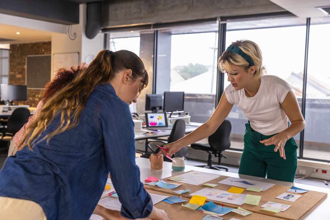 Diverse Coworkers Brainstorming with Notes in Modern Office Setting