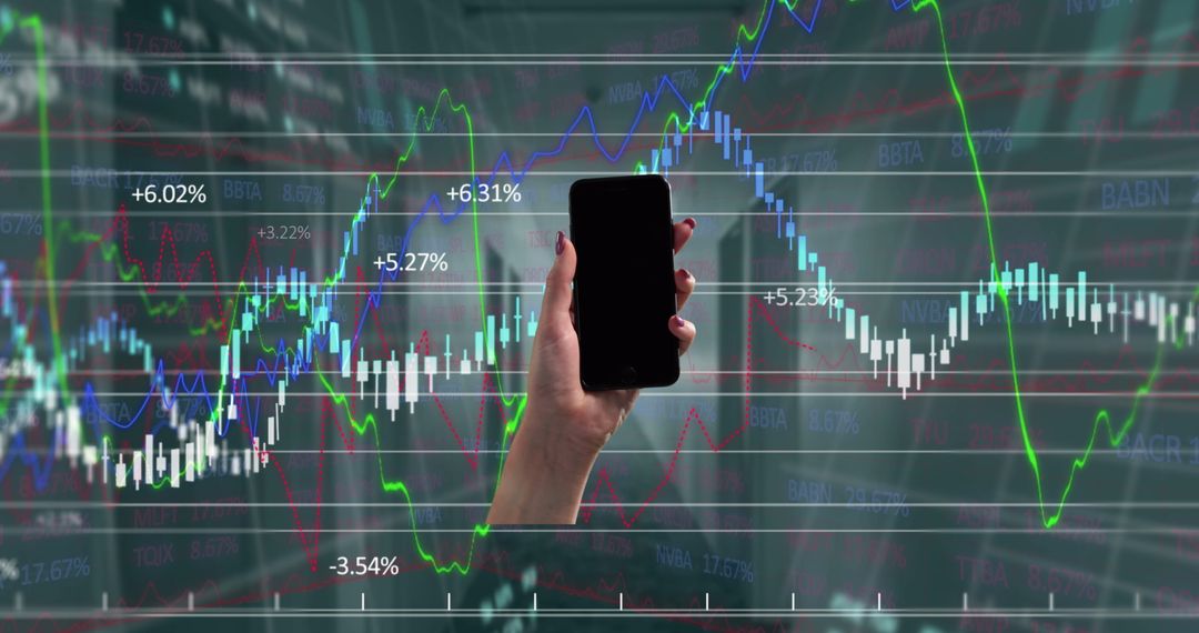 Hand Holding Smartphone with Financial Stock Charts Background