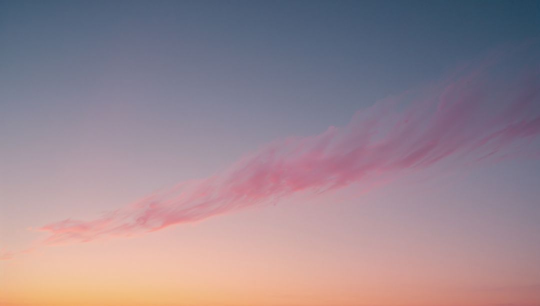 Pink Cloud Streak at Sunrise in Atmospheric Sky