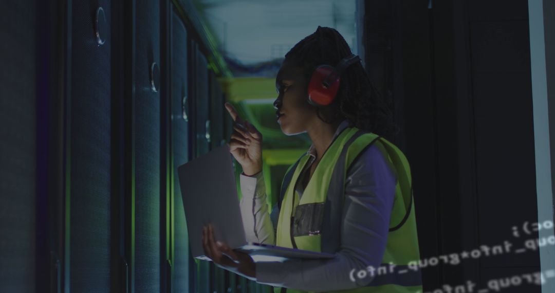 Female Technician Monitoring Servers in Data Center