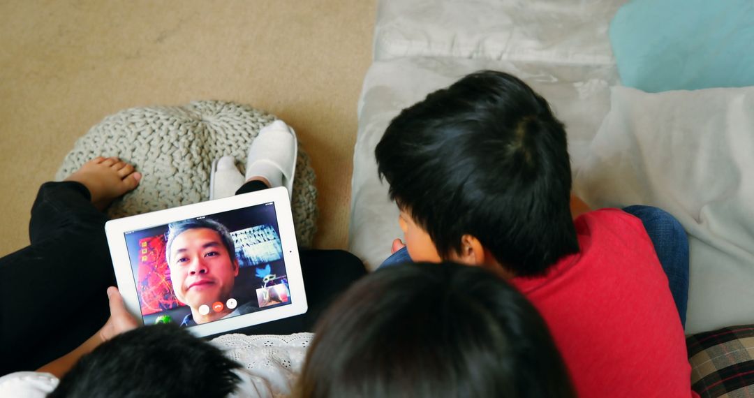 Children Video Chatting with Father on Tablet at Home - Free Images, Stock Photos and Pictures on Pikwizard.com