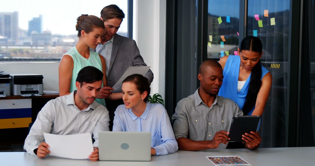 Diverse Team Collaborating in Modern Office with Digital Devices