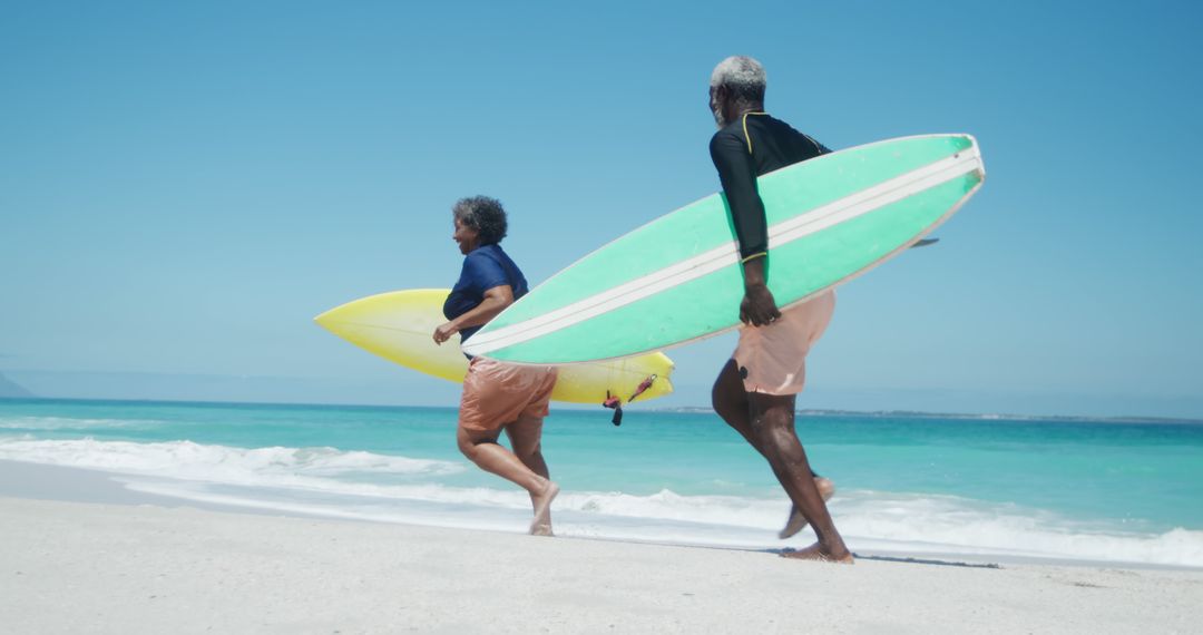 Two Senior Surfers Carrying Surfboards on Tropical Beach - Free Images, Stock Photos and Pictures on Pikwizard.com