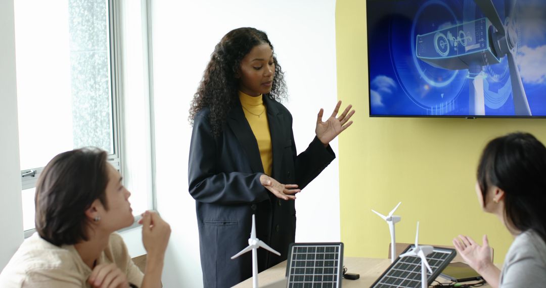 Team Collaborating on Sustainable Energy Solutions in Modern Office