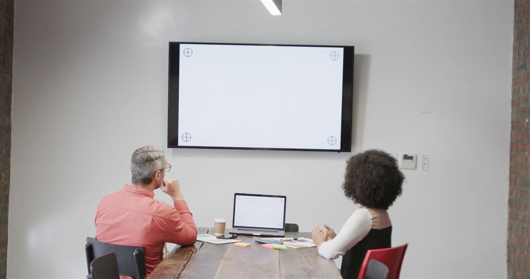 Business Colleagues Watching Presentation on Blank Screen in Modern Meeting Room - Free Images, Stock Photos and Pictures on Pikwizard.com