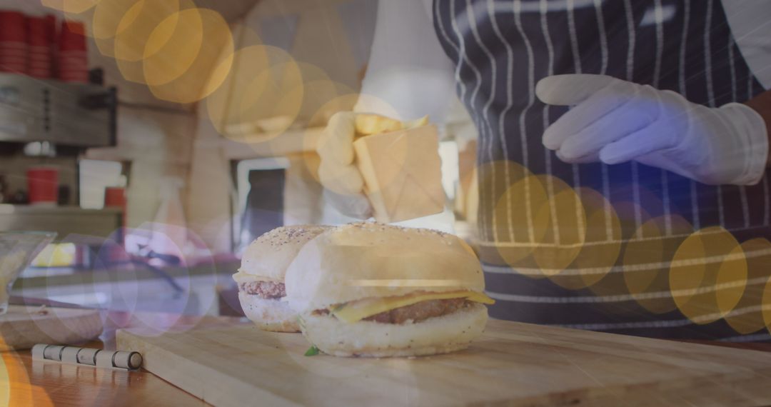 Chef Preparing Burgers with Cheese in Kitchen