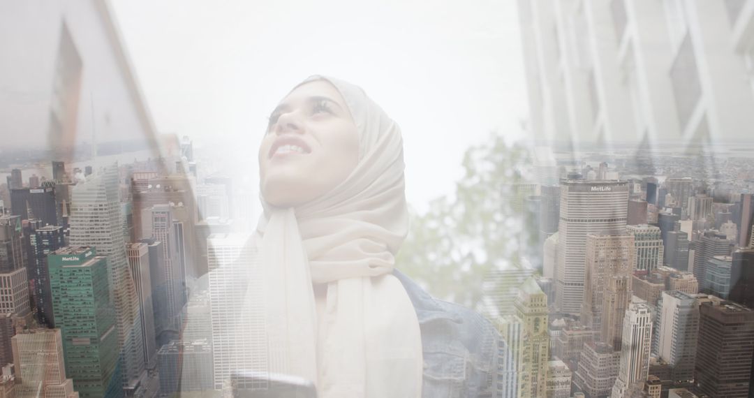 Smiling Asian Woman in Hijab Using Smartphone in Urban Cityscape