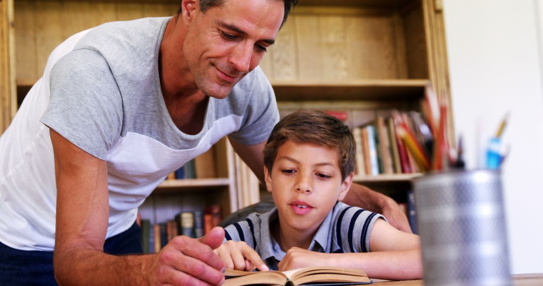 Father Helping Son with Reading at Home in a Cozy Room - Free Images, Stock Photos and Pictures on Pikwizard.com