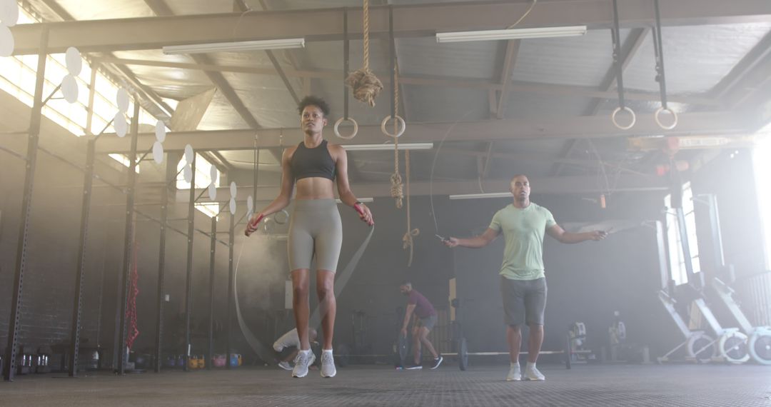 Athletic Individuals Jumping Rope in Gym Environment - Free Images, Stock Photos and Pictures on Pikwizard.com