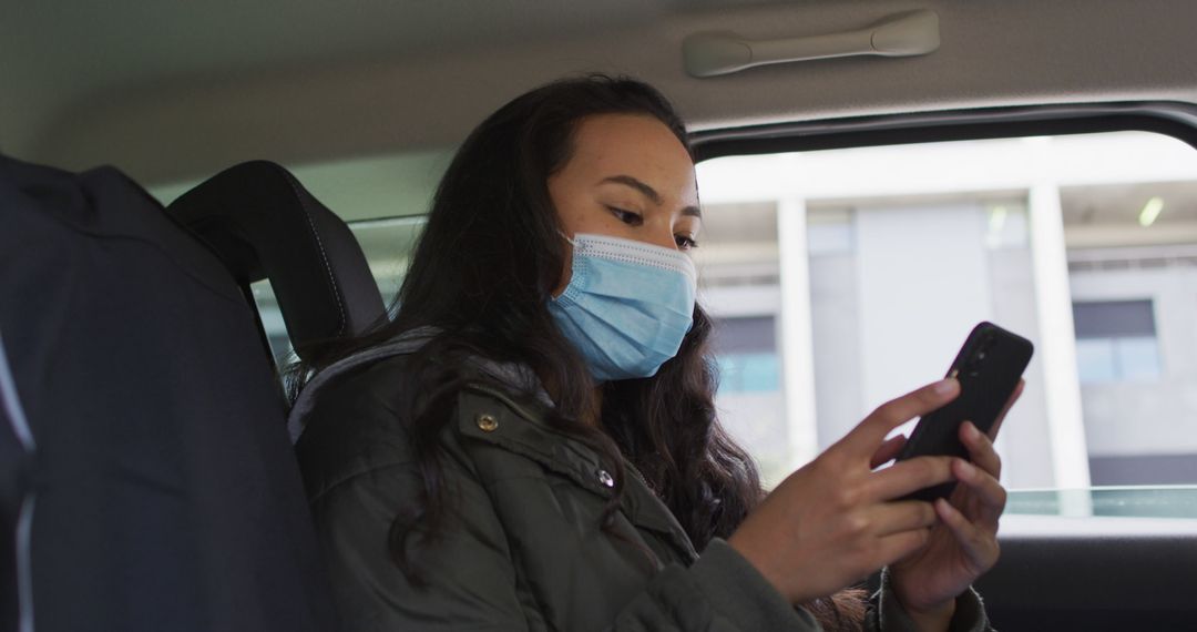 Young Woman Wearing Face Mask Using Smartphone in Car - Free Images, Stock Photos and Pictures on Pikwizard.com