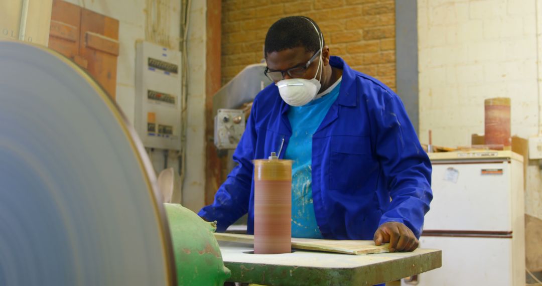 Worker Sanding Wooden Object in Workshop - Free Images, Stock Photos and Pictures on Pikwizard.com