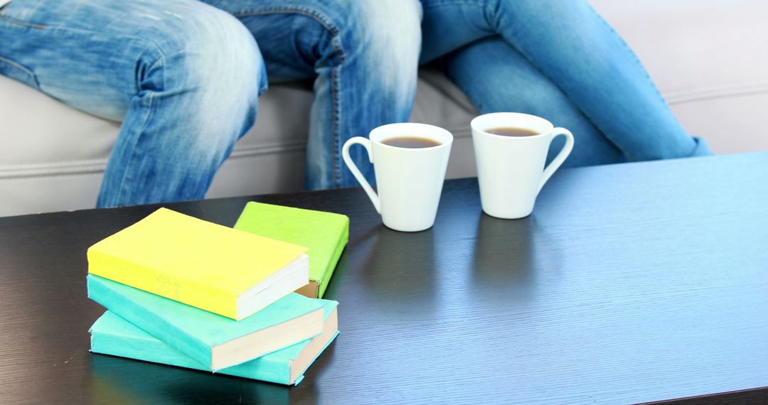 Relaxed Coffee Break at Home with Colorful Books and Two Cups - Free Images, Stock Photos and Pictures on Pikwizard.com