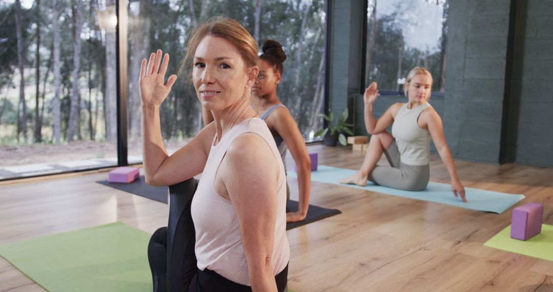 Women Practicing Yoga in Modern Studio with Forest View - Free Images, Stock Photos and Pictures on Pikwizard.com