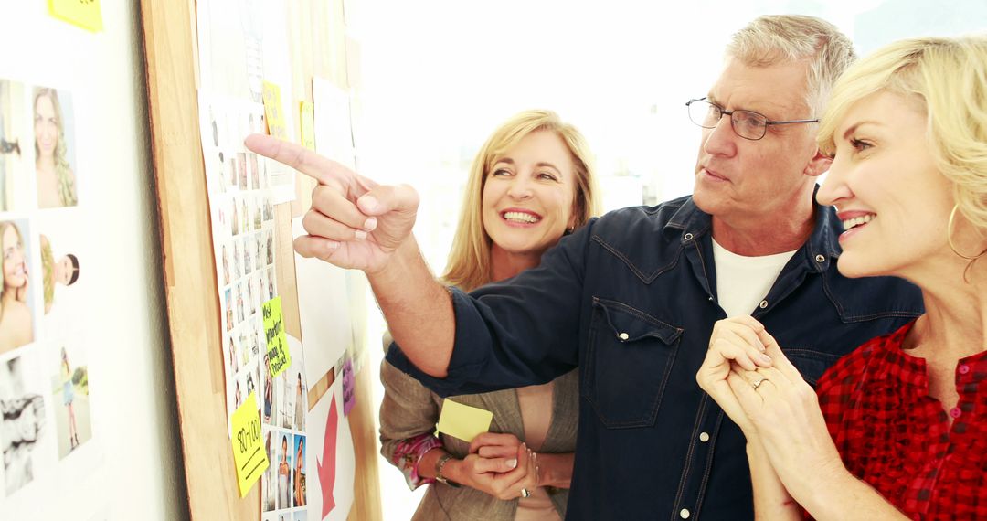 Middle-Aged Professionals Collaborating in Creative Planning Session