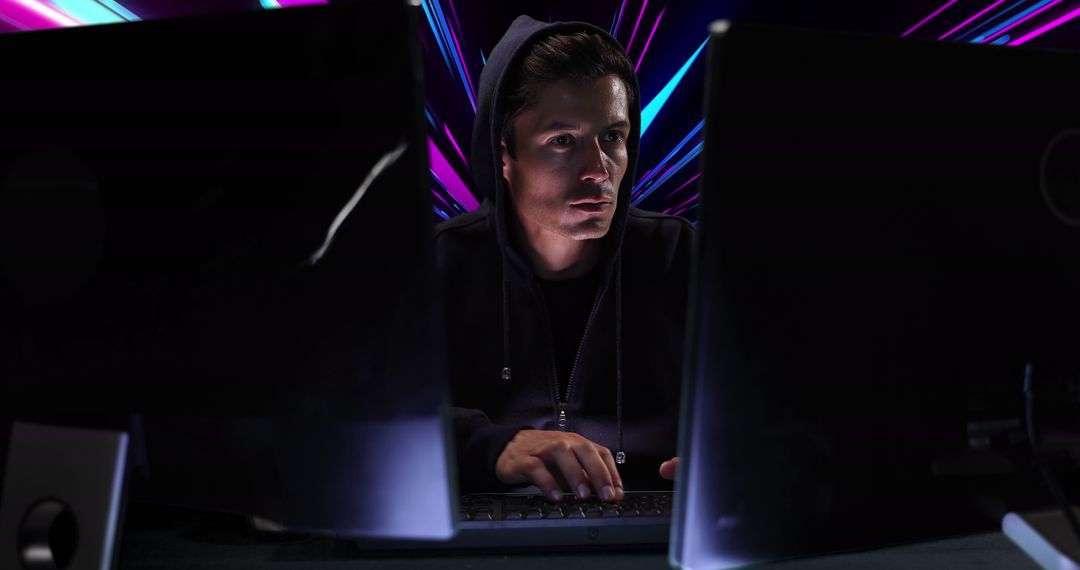 Focused Hacker Engaging in Cybersecurity with Neon Background
