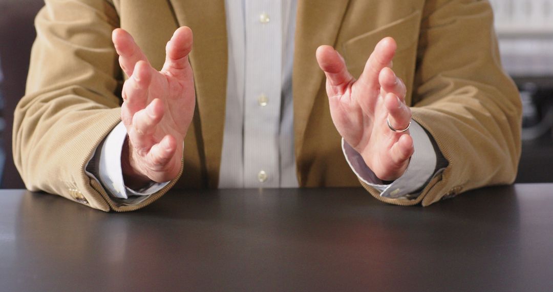 Anxious Businessman Tapping Fingers on Desk in Office