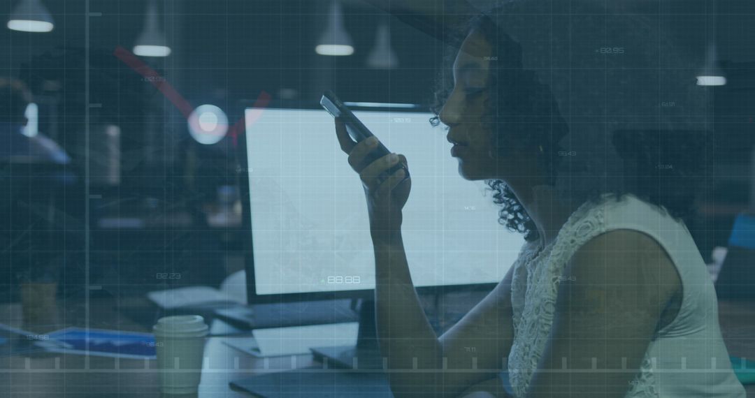 Biracial Businesswoman Engaging with Smartphone in Modern Office