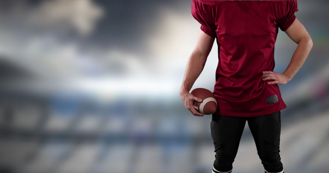 American football player in red jersey holding ball in stadium - Free Images, Stock Photos and Pictures on Pikwizard.com