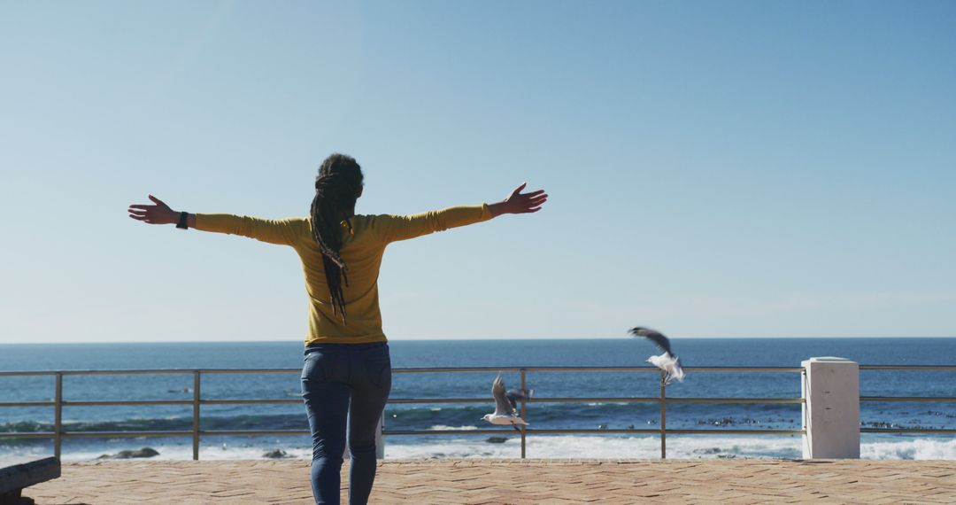 Person Enjoying Freedom by Ocean with Open Arms - Free Images, Stock Photos and Pictures on Pikwizard.com