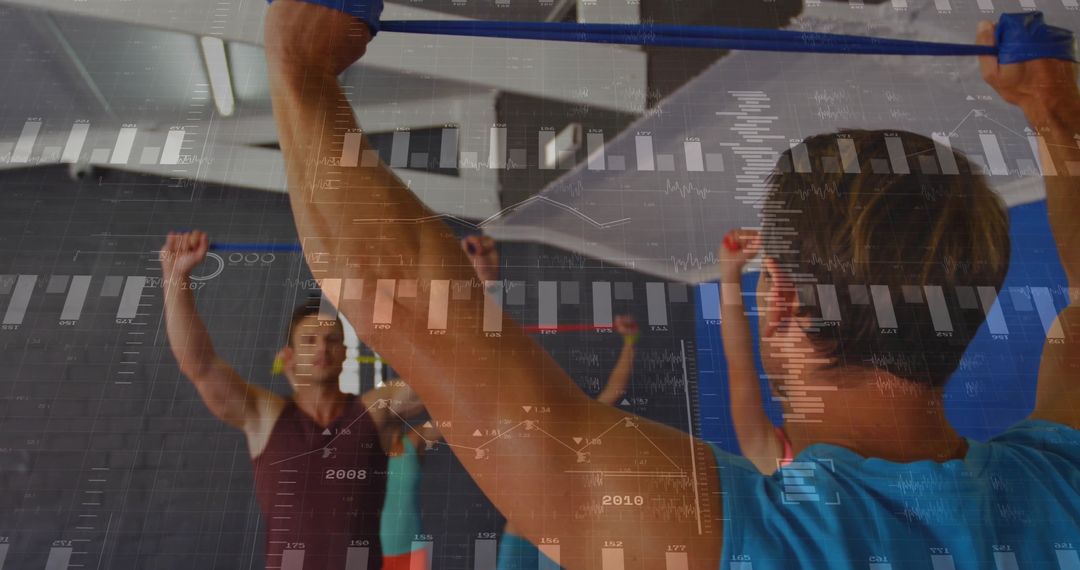 Instructor Leading Group Stretch with Elastic Bands in Fitness Studio