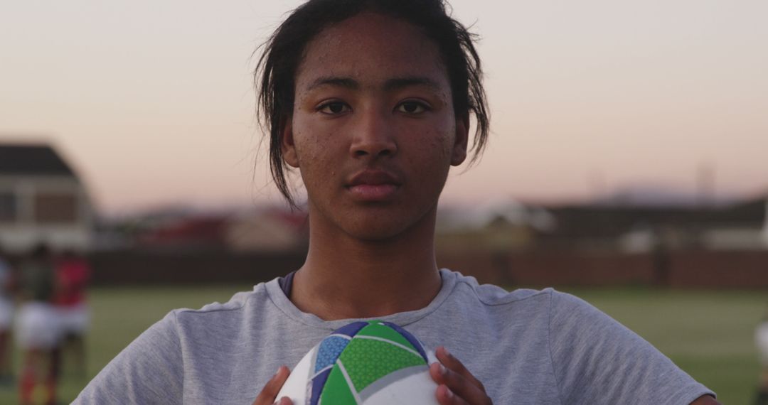 Confident Female Rugby Player Holding Ball at Sunset - Free Images, Stock Photos and Pictures on Pikwizard.com