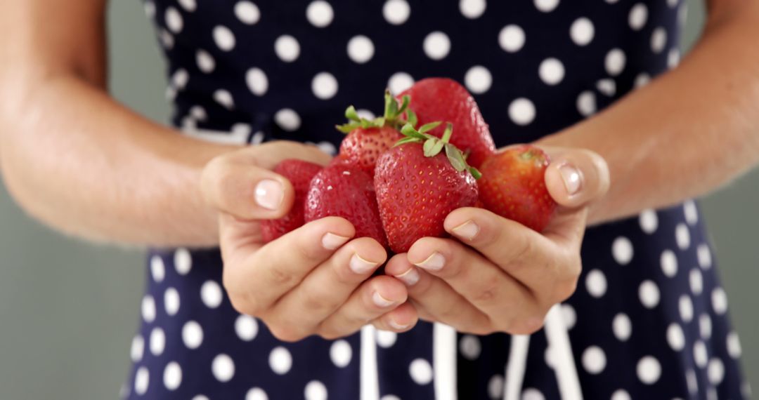 Close-up of Hands Holding Fresh Strawberries in Polka Dot Dress - Free Images, Stock Photos and Pictures on Pikwizard.com