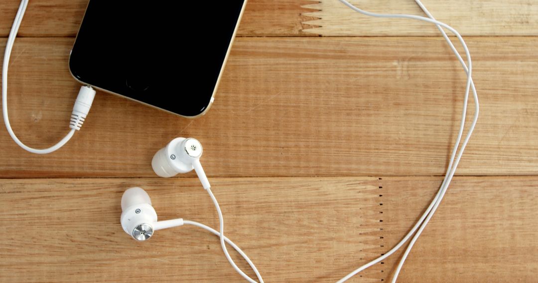 Smartphone with White Earbuds on Wooden Surface for Casual Music Listening - Free Images, Stock Photos and Pictures on Pikwizard.com