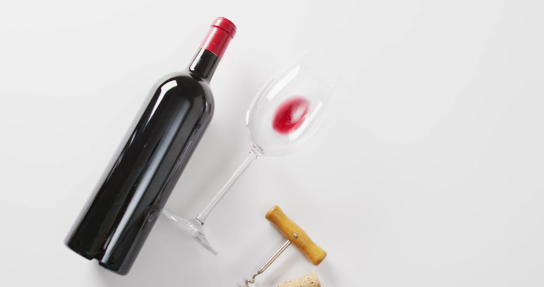 Open Bottle of Red Wine with Glass and Corkscrew Overlight