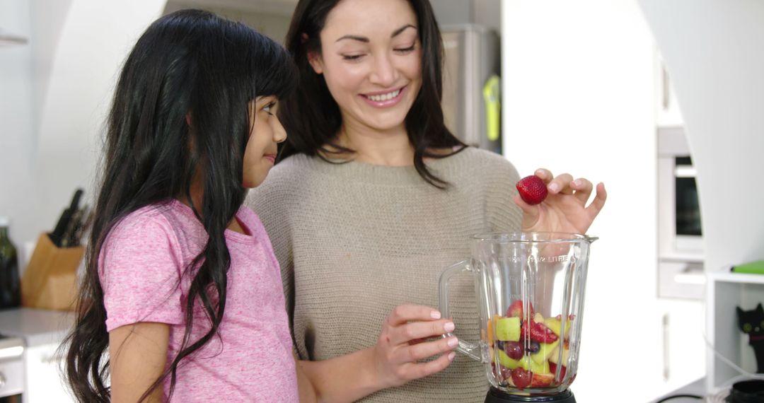 Mother and Daughter Enjoy Making Healthy Smoothies Together - Free Images, Stock Photos and Pictures on Pikwizard.com