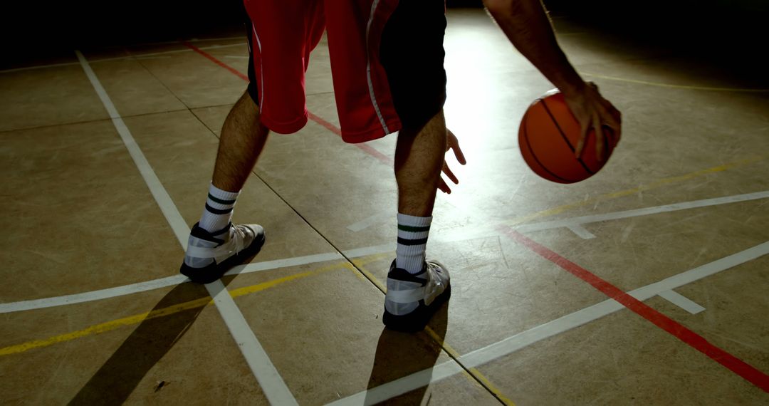 Young Caucasian Man Dribbling Basketball on Indoor Court Focused on Athletic Fitness - Free Images, Stock Photos and Pictures on Pikwizard.com