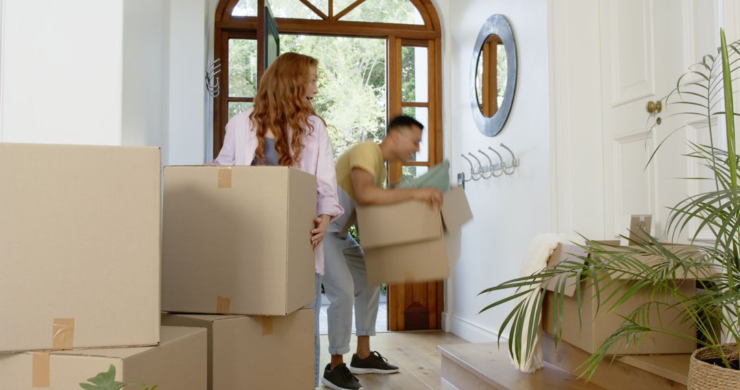 Couple Joyfully Moving Into New Home with Boxes
