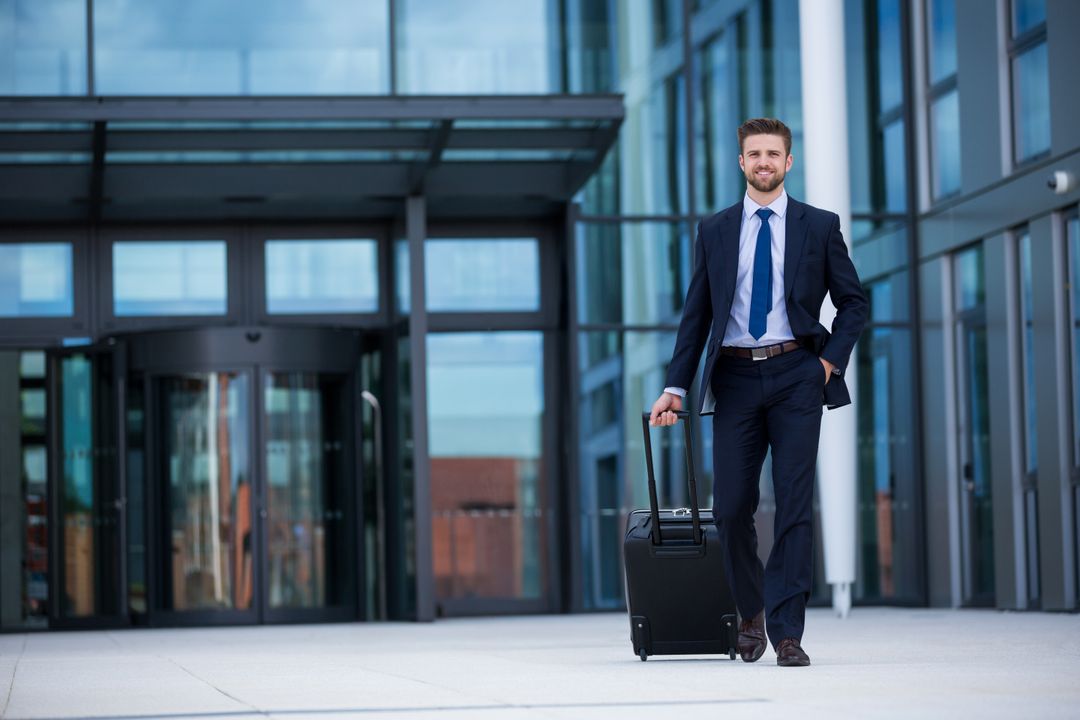 Confident Businessman with Luggage at Modern Office Complex