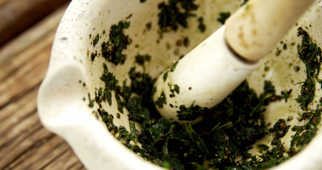 Mortar and Pestle with Freshly Ground Herbs - Free Images, Stock Photos and Pictures on Pikwizard.com