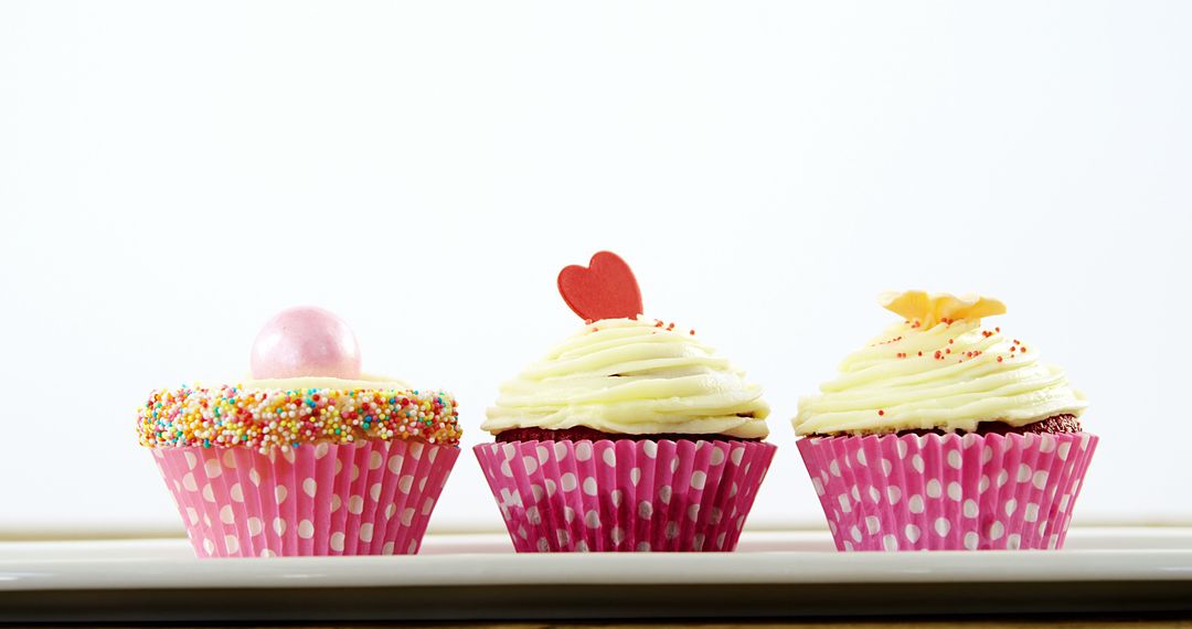 Colorful Cupcakes with Unique Toppings on White Background