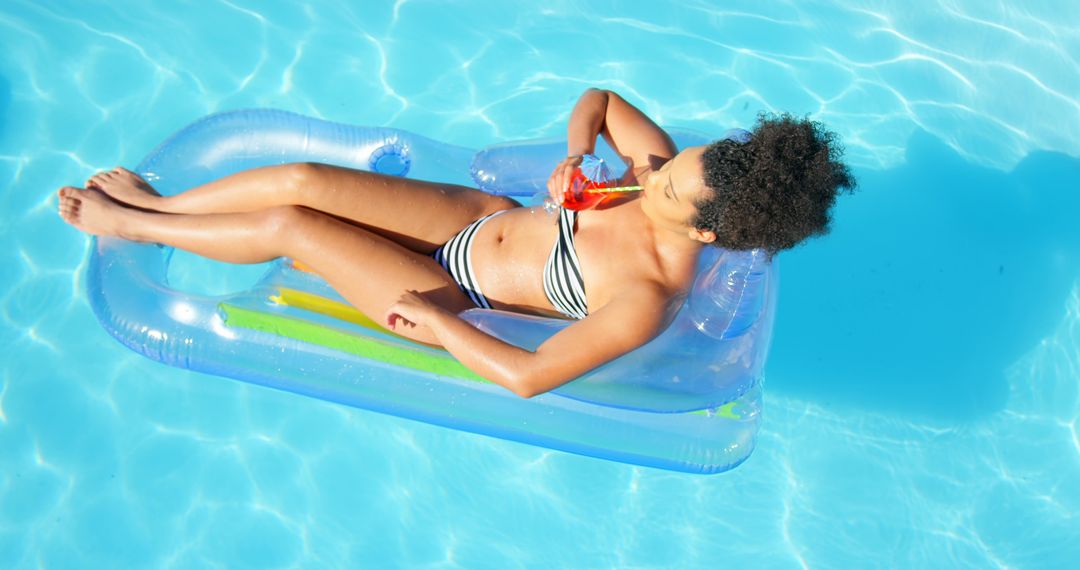 Young Woman Relaxing on Pool Float with Drink - Free Images, Stock Photos and Pictures on Pikwizard.com