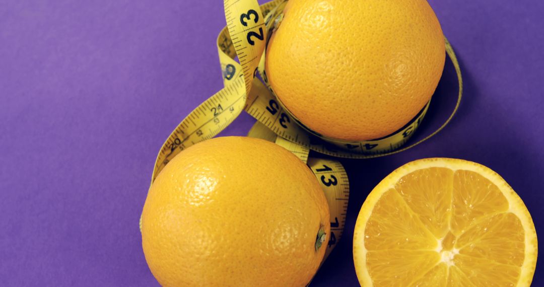 Fresh Grapefruits Wrapped in Measuring Tape on Purple Background - Free Images, Stock Photos and Pictures on Pikwizard.com