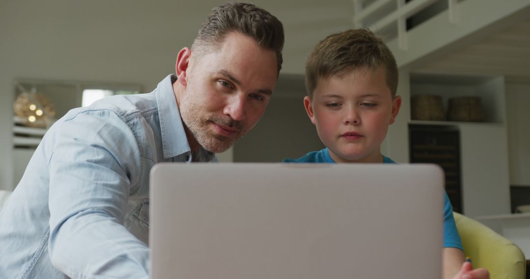 Father Helping Son with Online Learning at Home - Free Images, Stock Photos and Pictures on Pikwizard.com