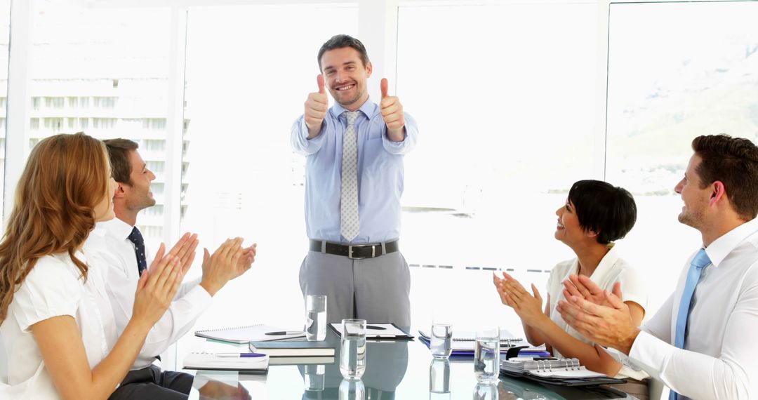 Business Team Applauding Colleague Giving Thumbs Up During Meeting - Free Images, Stock Photos and Pictures on Pikwizard.com