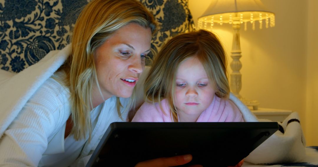 Mother and Daughter Enjoying Tablet Time in Cozy Bedroom - Free Images, Stock Photos and Pictures on Pikwizard.com