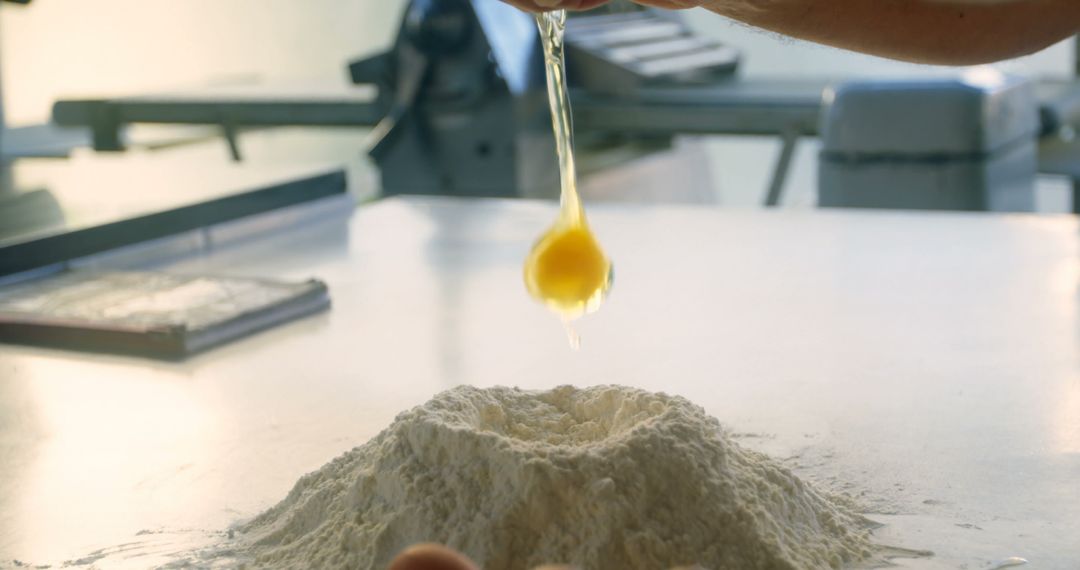 Baker Cracking Egg into Flour on Kitchen Counter  - Free Images, Stock Photos and Pictures on Pikwizard.com