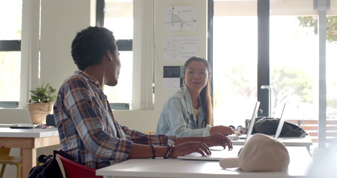 Teenagers Collaborating in Classroom with Laptops