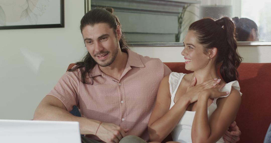 Happy Couple Engaging with Laptop Together at Home