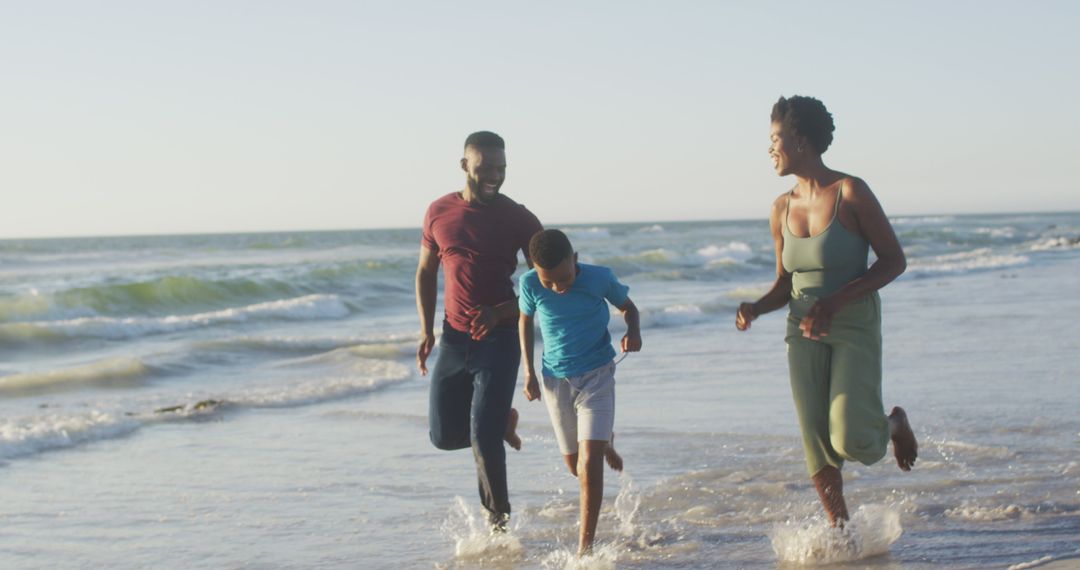 Happy Family Running on Beach at Sunset - Free Images, Stock Photos and Pictures on Pikwizard.com