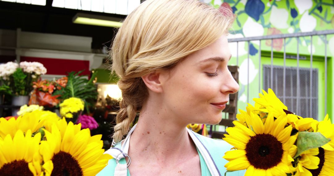 Smiling Blonde Woman with Sunflowers in Hand at Flower Shop - Free Images, Stock Photos and Pictures on Pikwizard.com