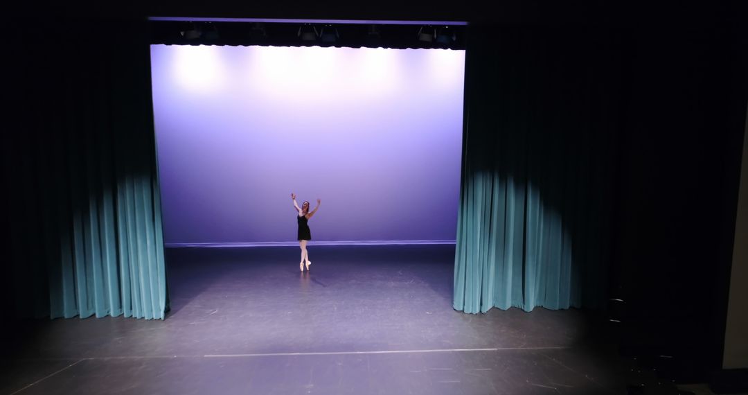 Young Female Ballet Dancer Practicing on Theater Stage