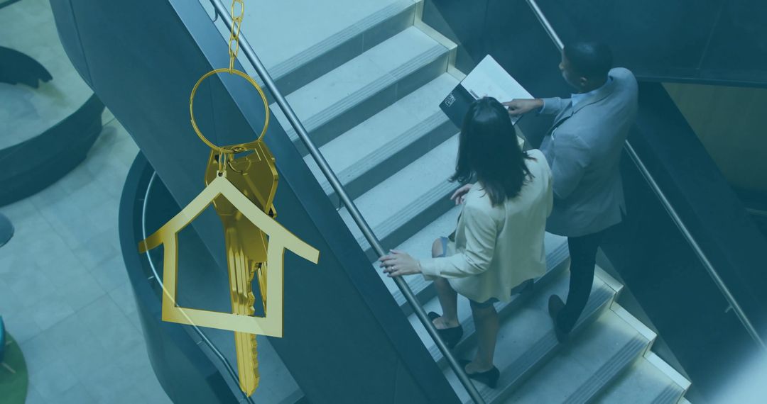 Diverse Businesspeople with Gold House Key Concept Image