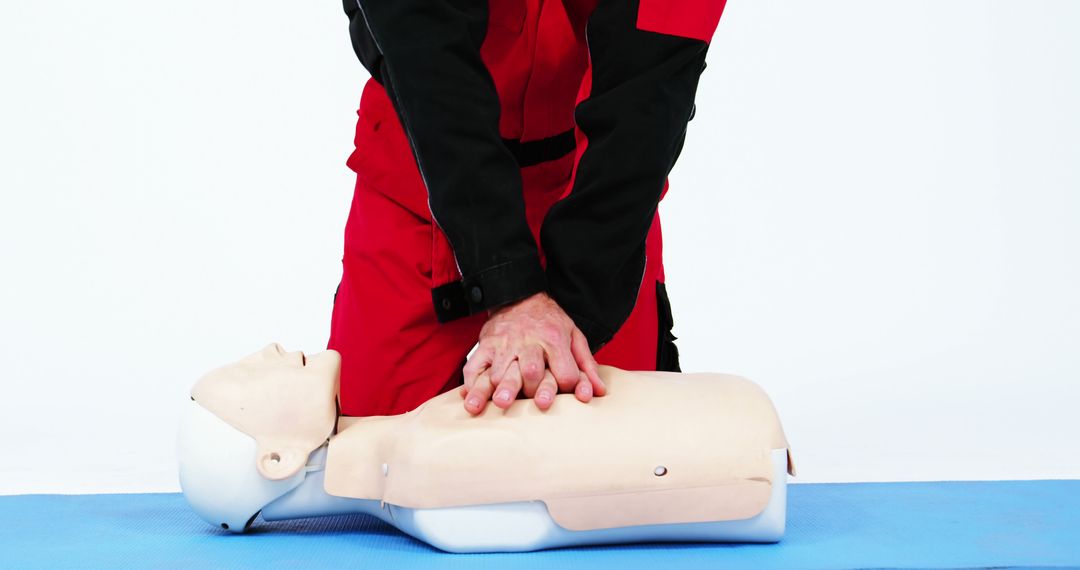 CPR Training on Dummy with Instructor in Red Uniform - Free Images, Stock Photos and Pictures on Pikwizard.com