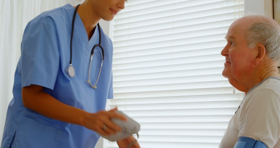 Healthcare Professional Taking Blood Pressure of Elderly Man at Home - Free Images, Stock Photos and Pictures on Pikwizard.com